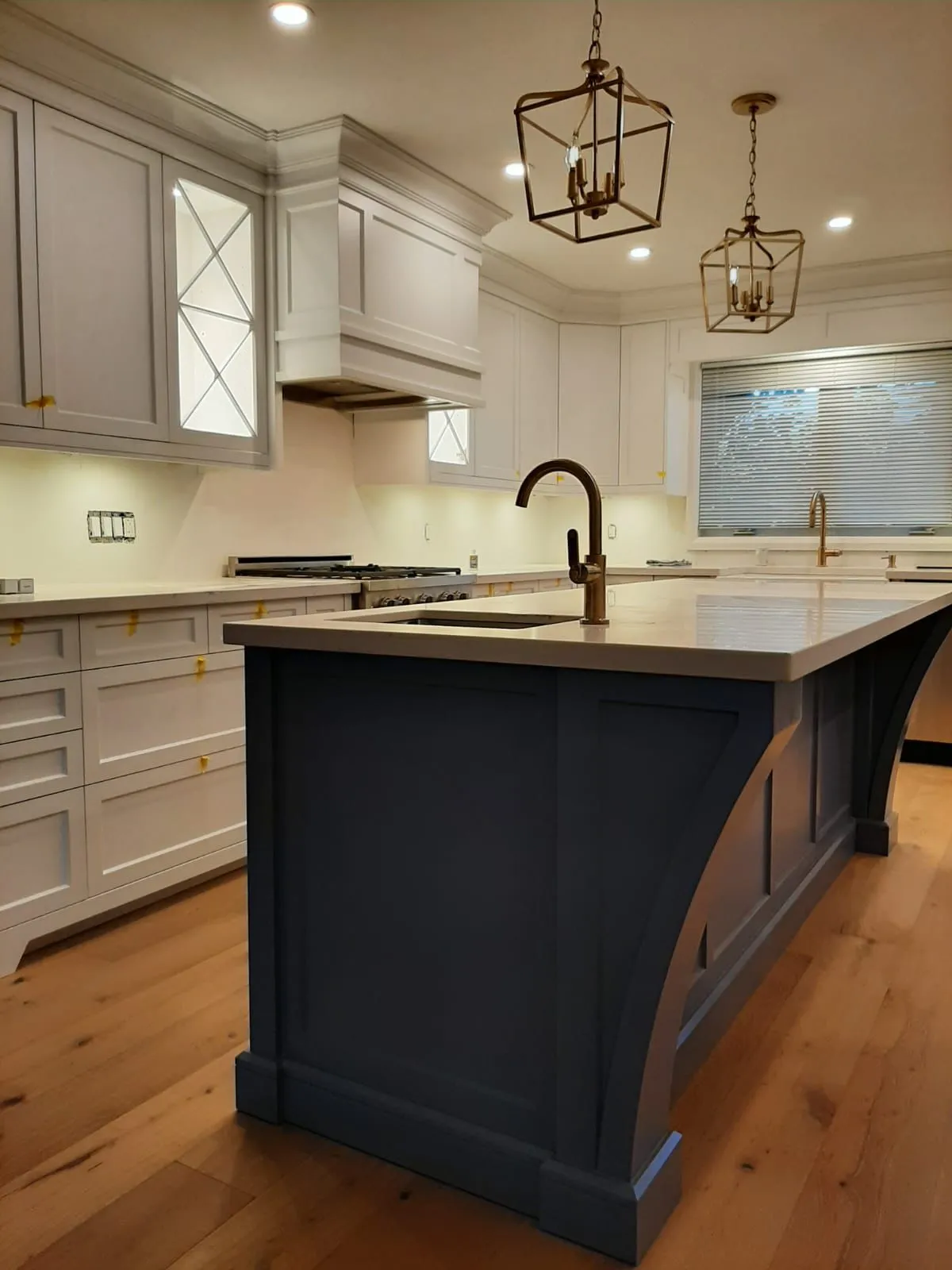 Traditional white custom kitchen with a dark island